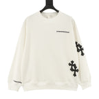 Cream long-sleeve crewneck sweatshirt with black cross patches on sleeves