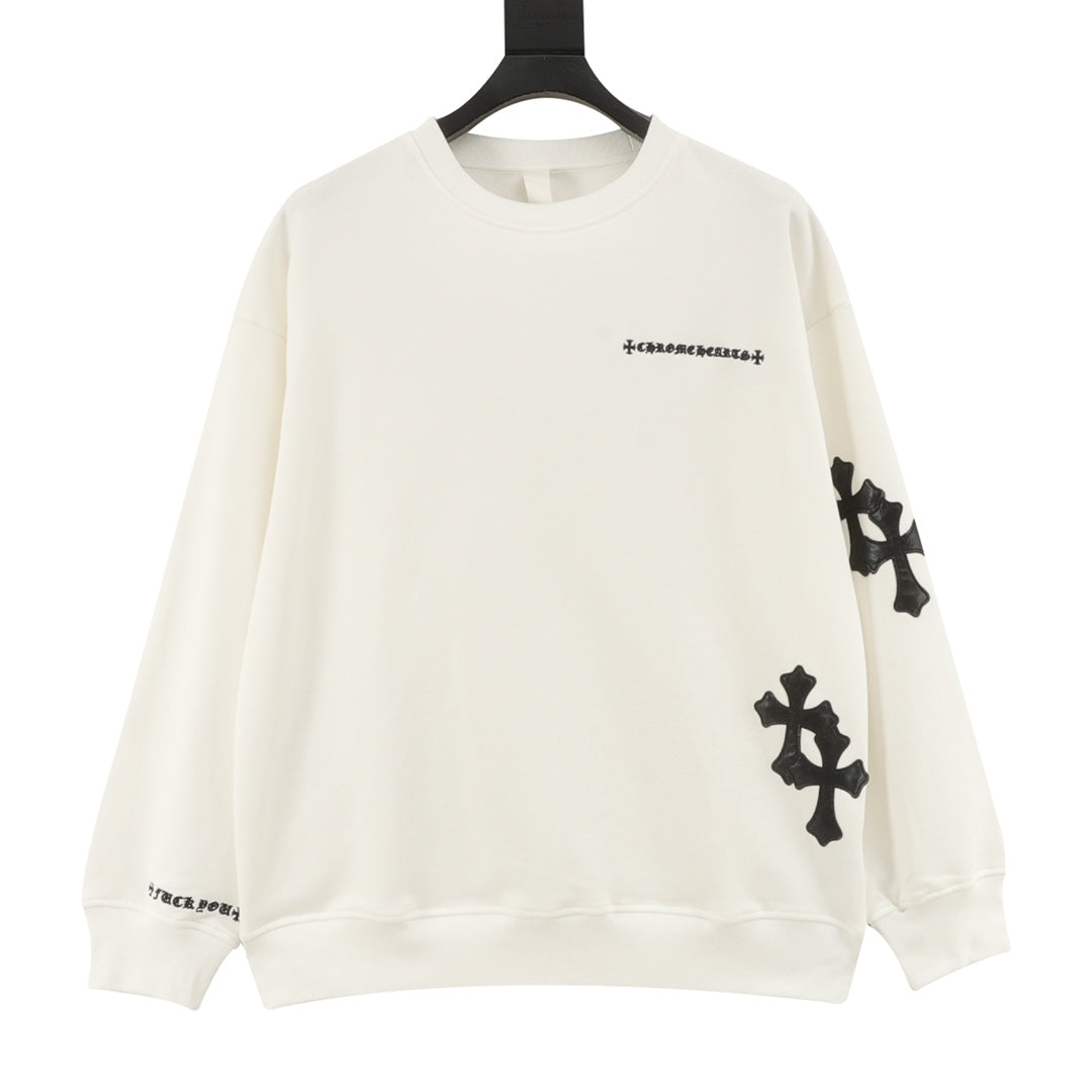 Cream long-sleeve crewneck sweatshirt with black cross patches on sleeves