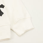 Cream sweatshirt sleeve cuffs with black appliqué cross details