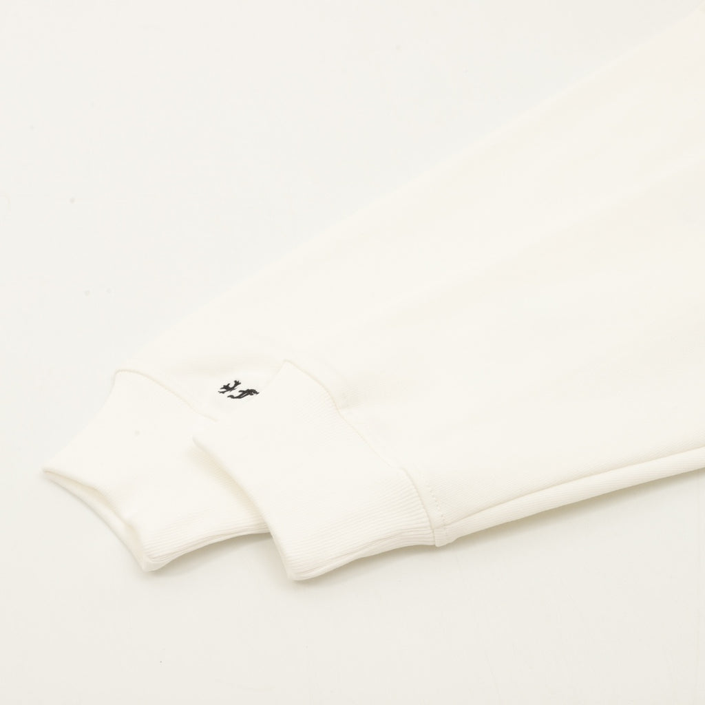 Cream sweatshirt hem and bottom band with small black logo mark