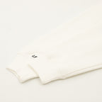 Cream sweatshirt hem and bottom band with small black logo mark