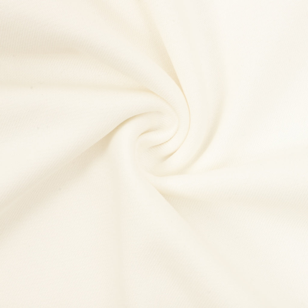 Cream sweatshirt fabric close-up with soft knit texture