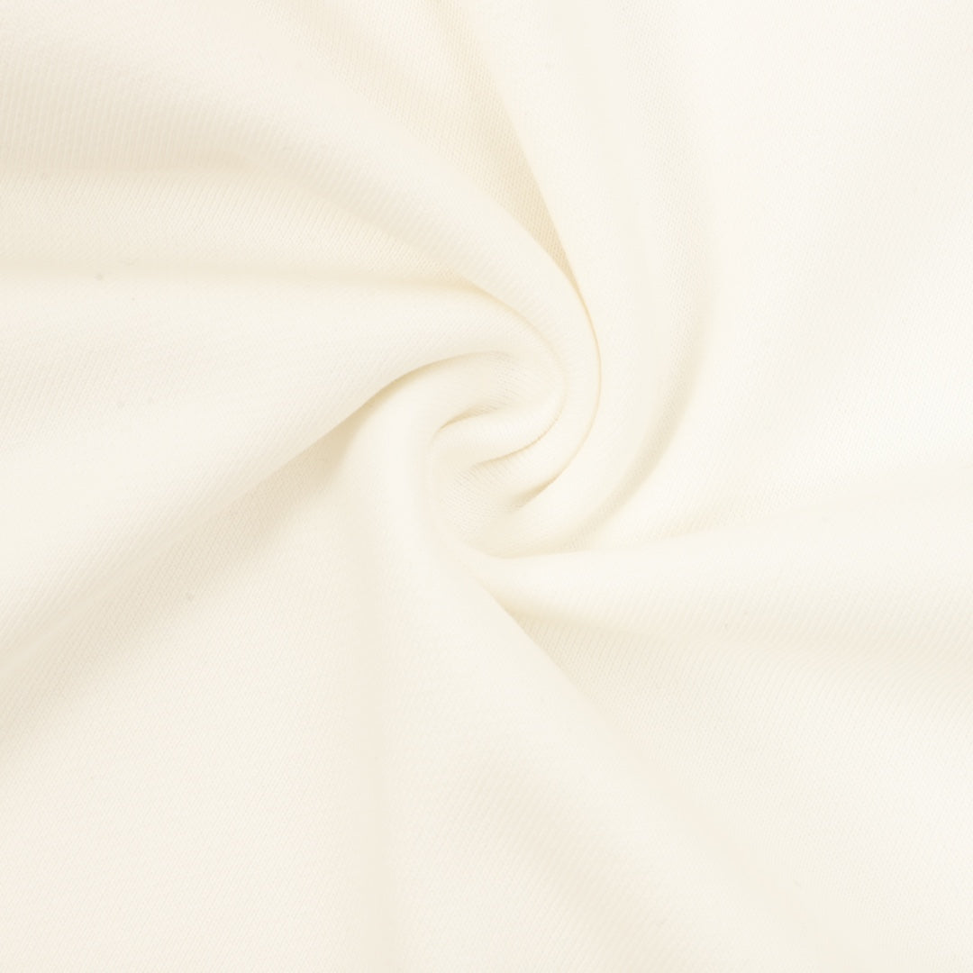 Cream sweatshirt fabric close-up with soft knit texture