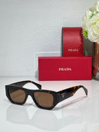 Prada black cat-eye sunglasses with brown lenses