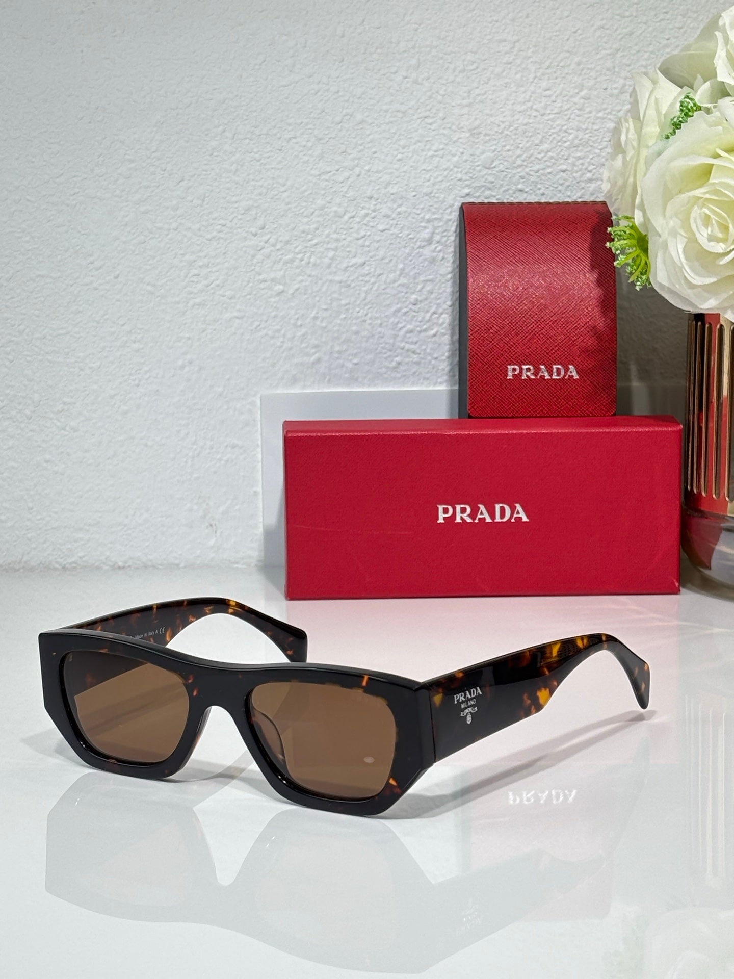 Prada black cat-eye sunglasses with brown lenses