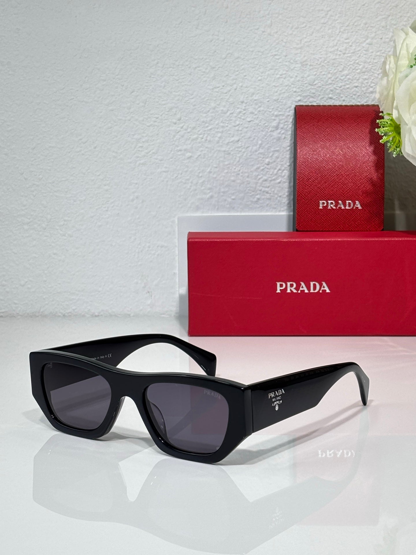 Prada black cat-eye sunglasses with dark gray lenses
