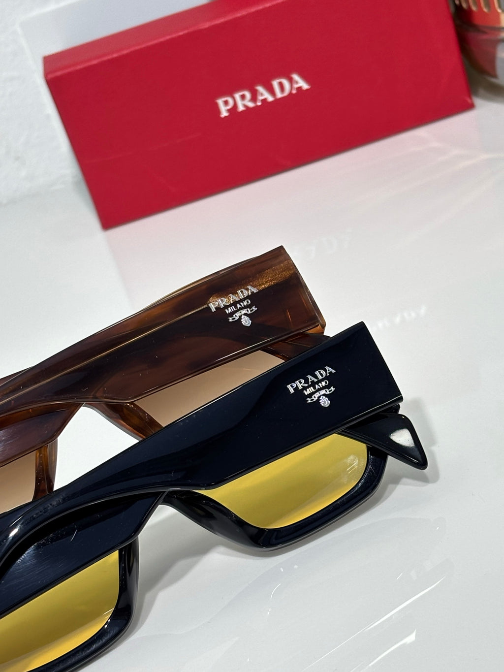 Prada sunglasses with tortoise and black frames, yellow lenses