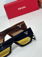 Prada sunglasses with tortoise and black frames, yellow lenses