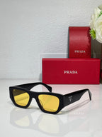 Prada black cat-eye sunglasses with yellow lenses