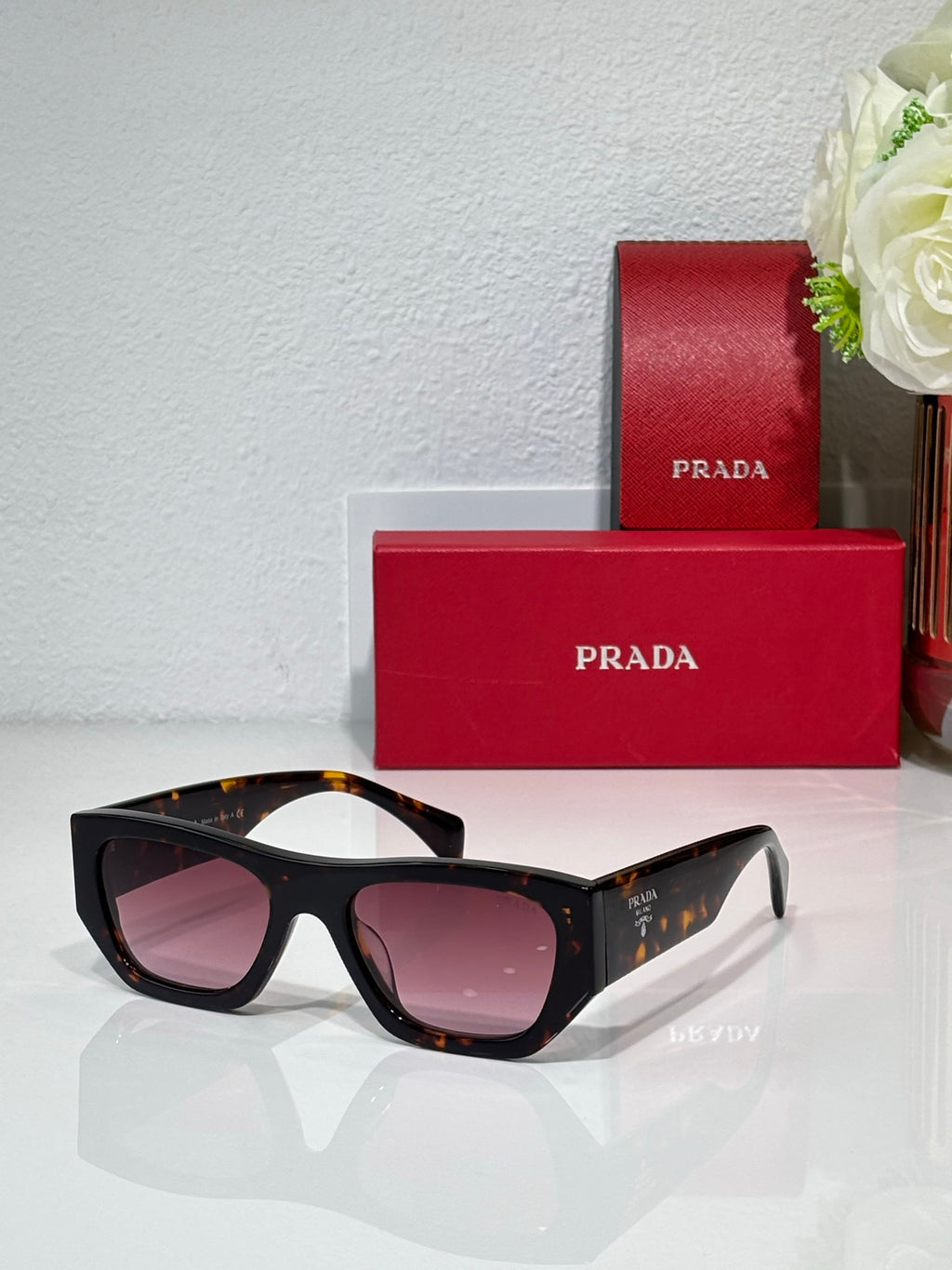 Prada black cat-eye sunglasses with pink lenses