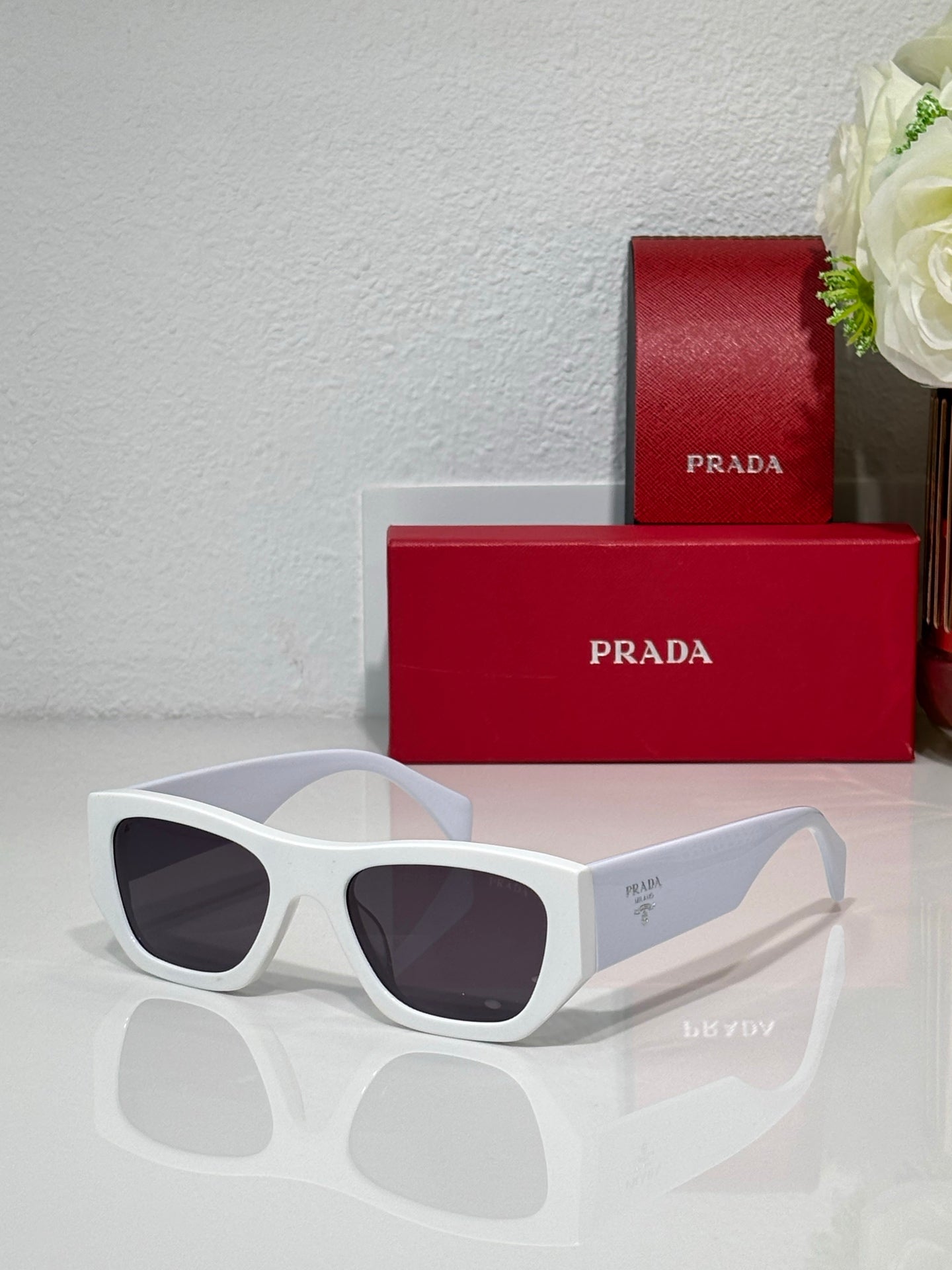 Prada white cat-eye sunglasses with dark lenses