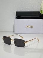 Dior sunglasses with dark lenses, gold-tone frame and metal temple arms