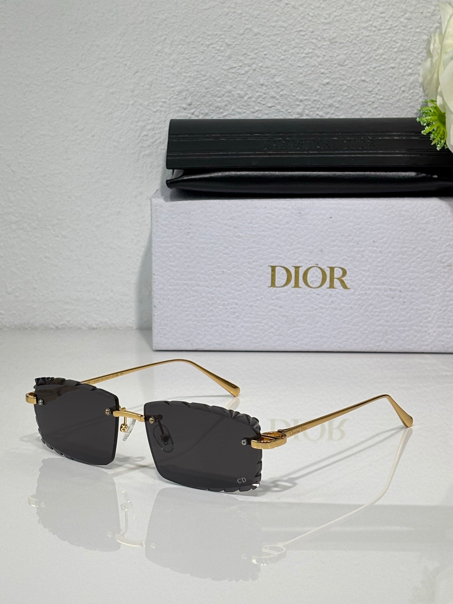 Dior sunglasses with dark lenses, gold-tone frame and metal temple arms