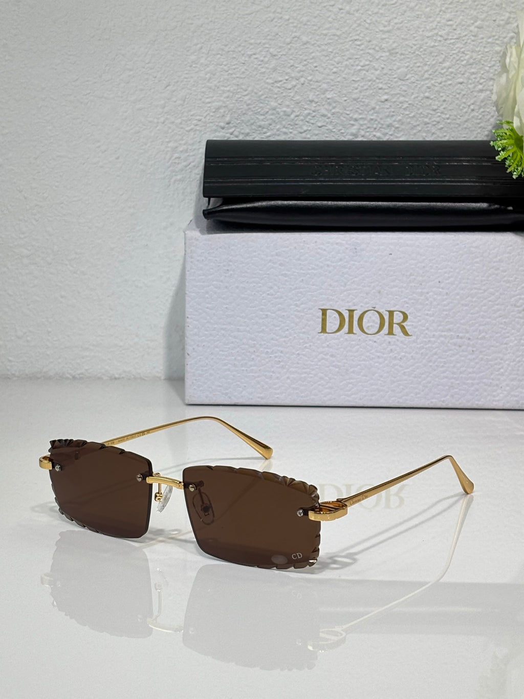 Dior sunglasses with brown lenses, gold-tone frame and curved metal temples
