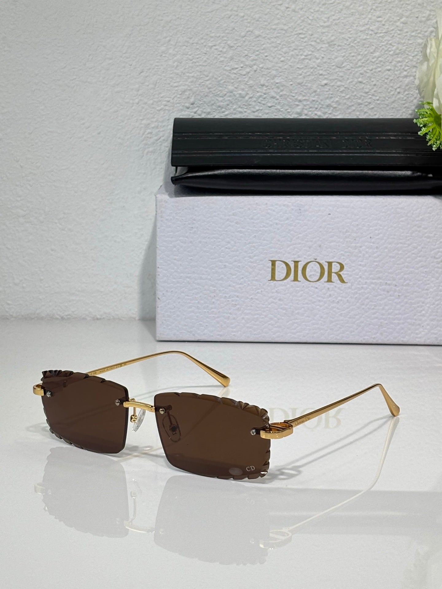 Dior sunglasses with brown lenses, gold-tone frame and curved metal temples