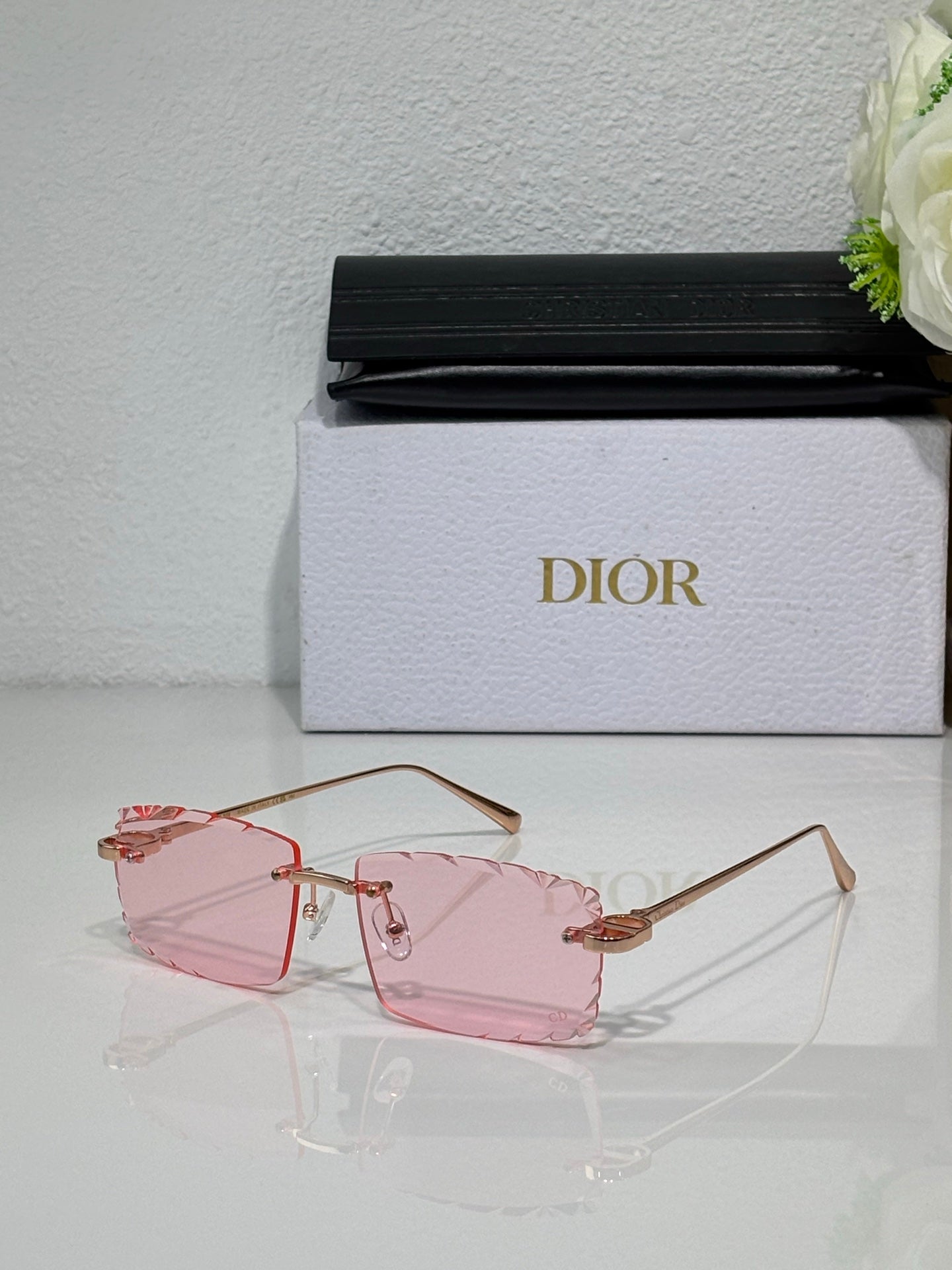 Dior sunglasses with pink-tinted lenses, gold-tone frame and delicate temples