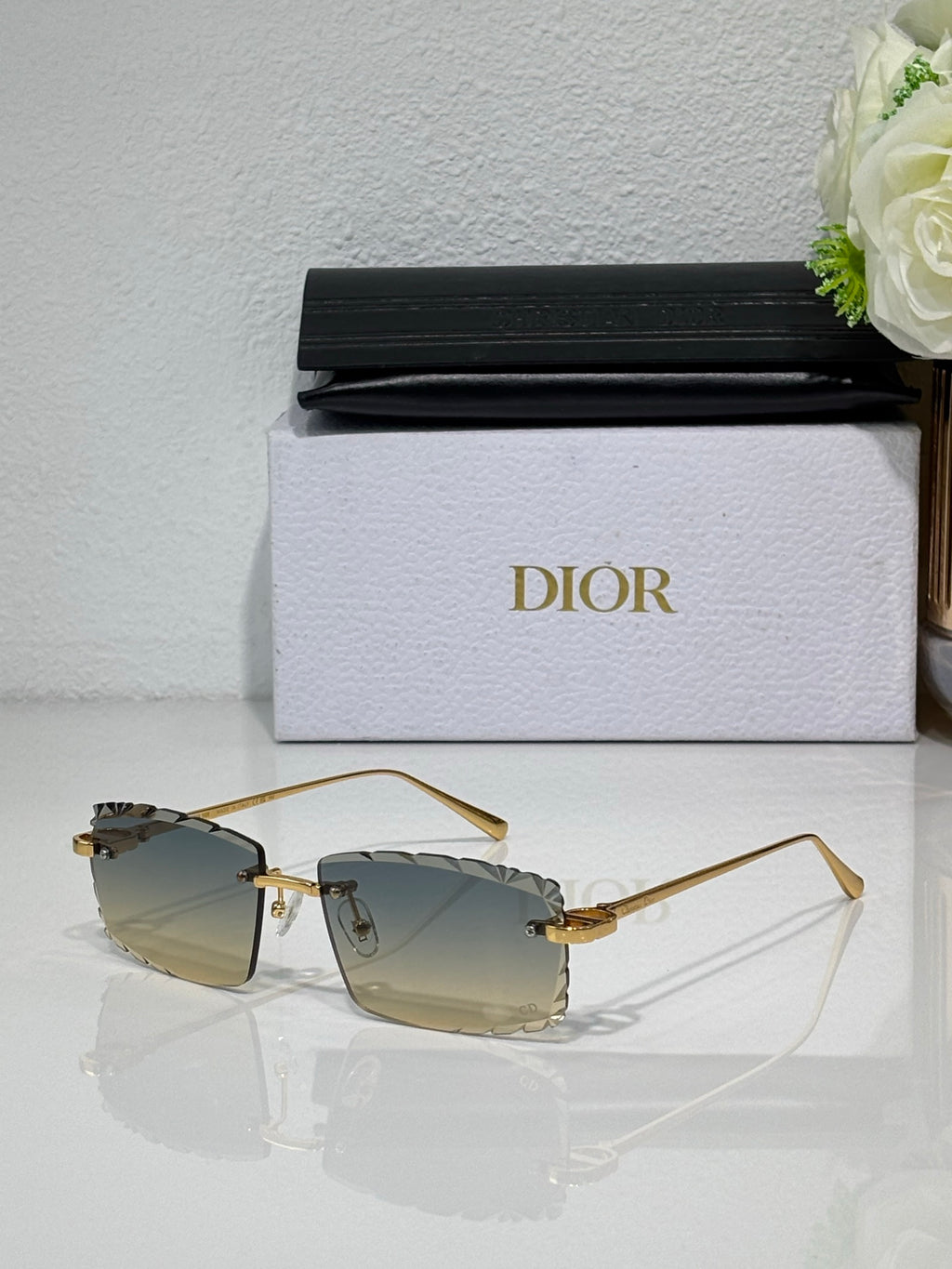 Dior sunglasses with light brown lenses, gold-tone frame and angular temples