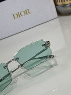 Dior sunglasses with mint-green lenses, close-up of hinge and temple hardware
