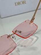 Dior sunglasses close-up with pink lenses and gold-tone temple hardware