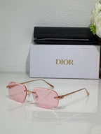 Sunglasses with pink tinted octagon lenses and thin gold-tone metal frame