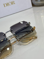 Sunglasses close-up with dark lenses, gold-tone arms, and metal details