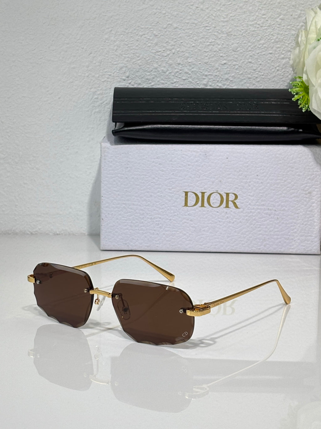 Sunglasses with brown tinted lenses and thin gold-tone metal frame
