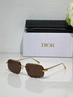 Sunglasses with brown tinted lenses and thin gold-tone metal frame