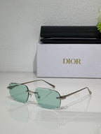 Sunglasses with mint green tinted lenses and thin gold-tone metal frame