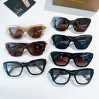Assorted sunglasses set with dark, blue, tortoiseshell, and red frames with gold accents