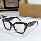 Tortoiseshell sunglasses with amber-brown lenses and gold medallion detail on the temples