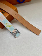 Tan leather belt strap with punched holes and patterned buckle attachment