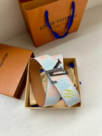 Patterned canvas belt in open box with silver buckle and tan leather strap