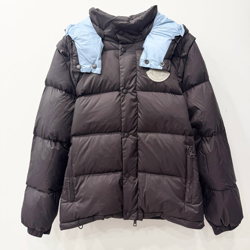 Long dark puffer jacket with hood, quilted panels, snap buttons, elastic cuffs