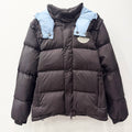 Long dark puffer jacket with hood, quilted panels, snap buttons, elastic cuffs