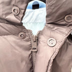 Puffer jacket zipper placket with metal snap buttons and contrasting inner lining