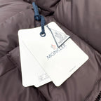 Moncler long coat with quilted shell and hanging brand tags
