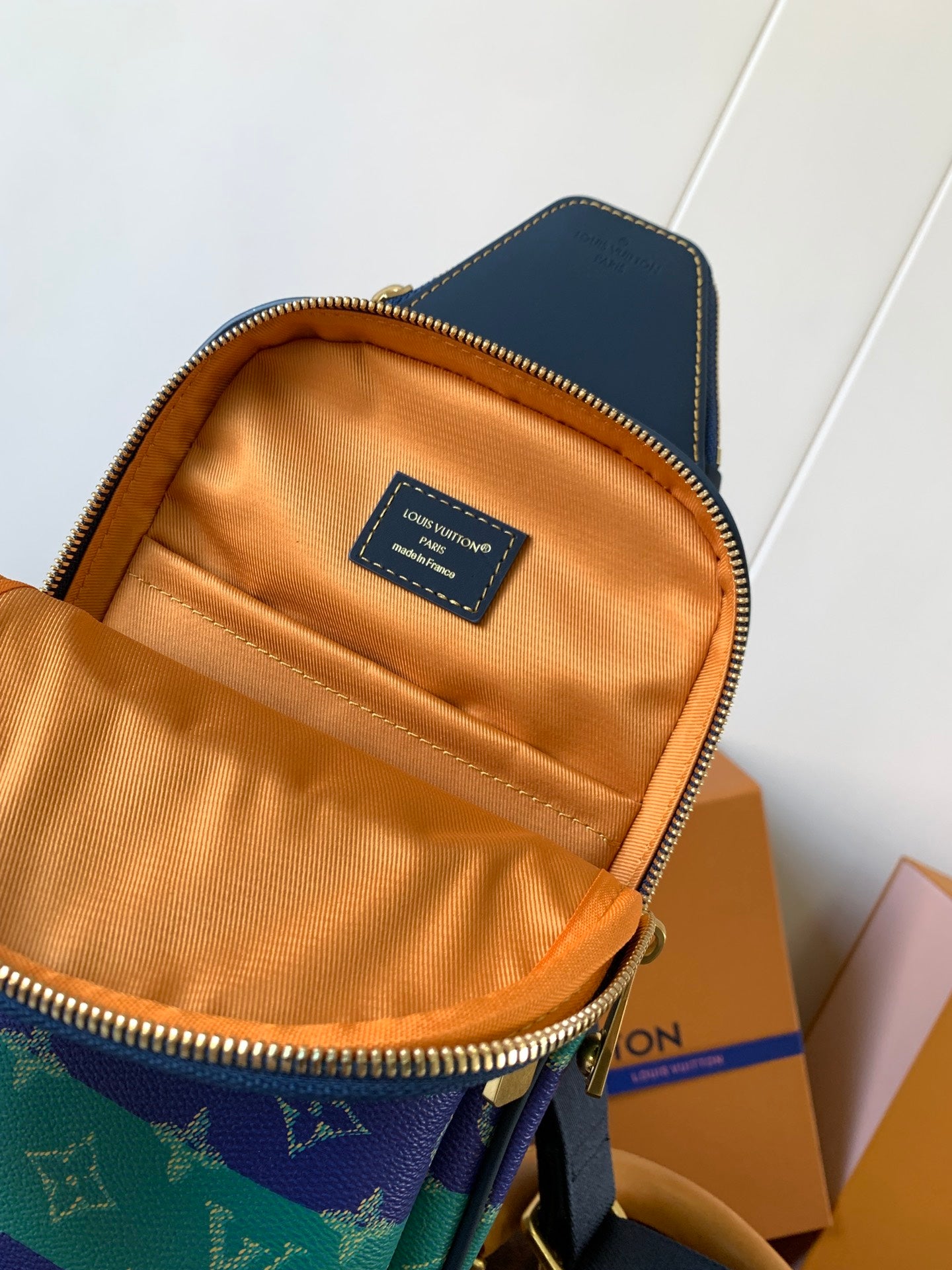 Louis Vuitton crossbody bag interior with tan lining and brand label on inner pocket