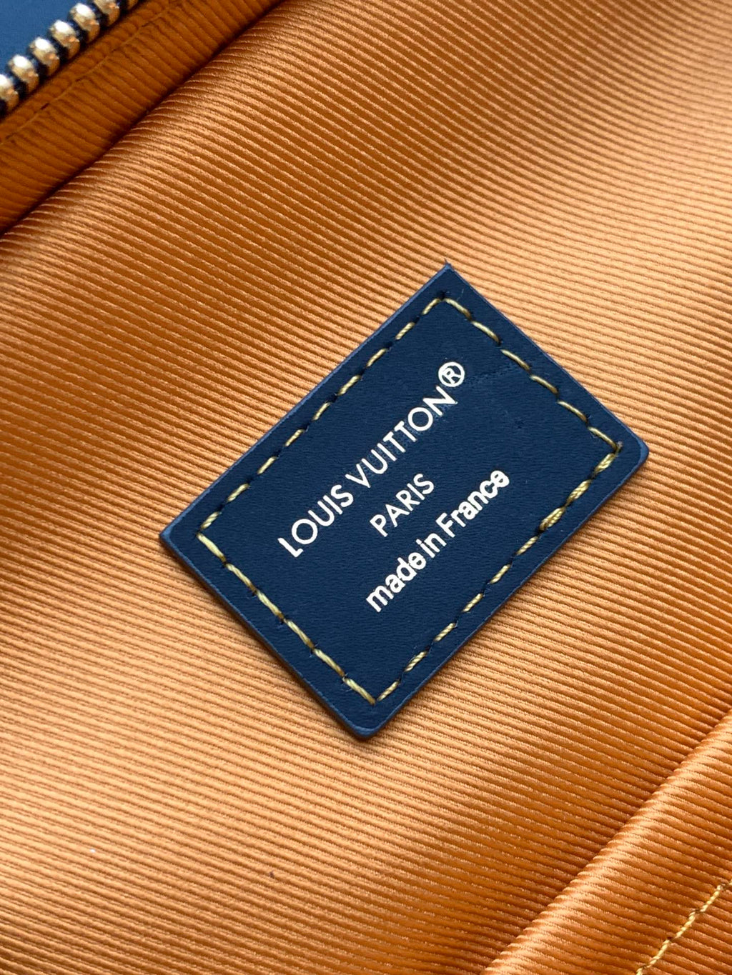Louis Vuitton inner label on tan lining: “Louis Vuitton Paris” and “made in France”