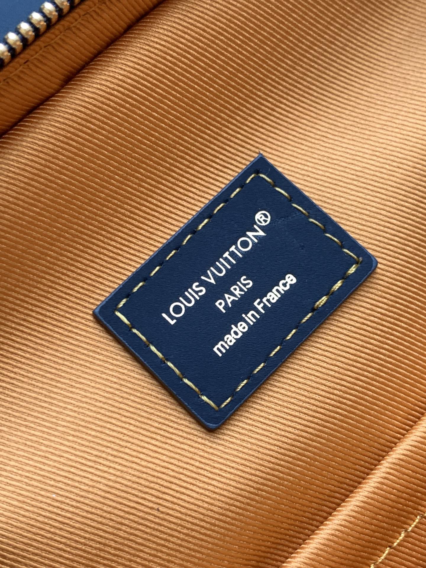 Louis Vuitton inner label on tan lining: “Louis Vuitton Paris” and “made in France”