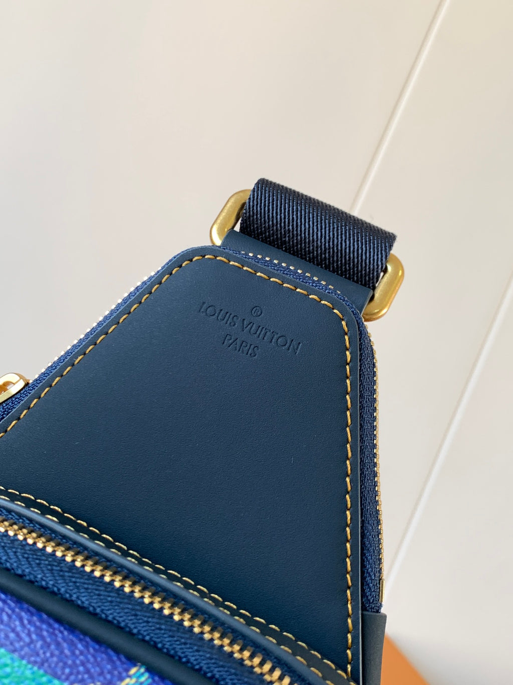 Louis Vuitton blue leather crossbody bag corner with gold zipper and contrast stitching