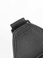 Louis Vuitton dark textured leather bag edge with stitched panels and side zipper pull