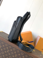 Louis Vuitton dark blue leather crossbody bag angled view with long strap and zipper top
