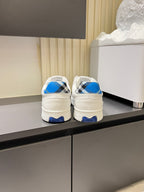 White Burberry sneakers rear view, blue heel tabs and black check detail