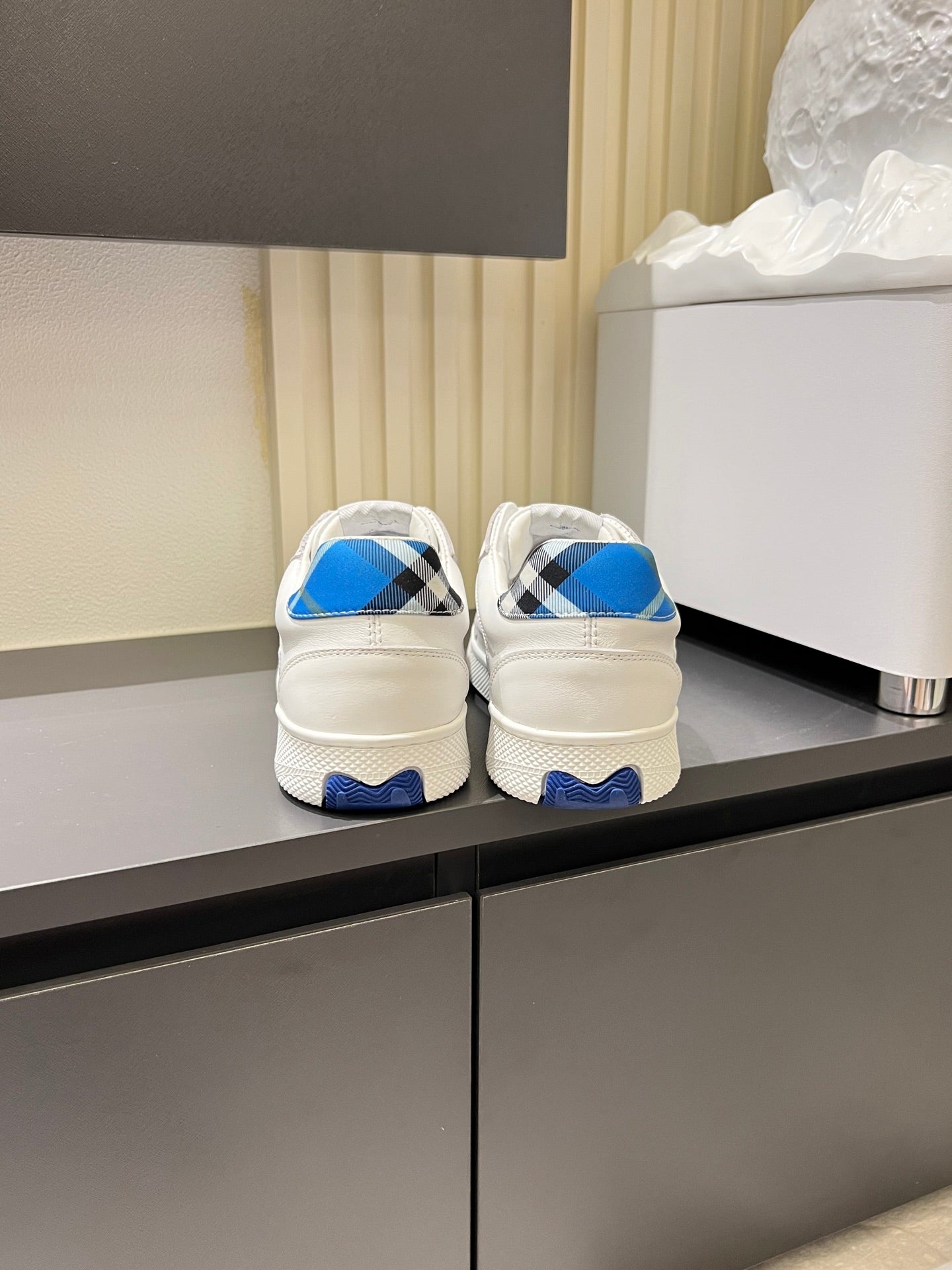 White Burberry sneakers rear view, blue heel tabs and black check detail