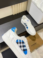 White Burberry sneakers close-up side view with blue and black check motif