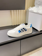 White Burberry low-top sneakers on display, blue and black check front panel