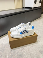 White Burberry sneakers side profile with blue leather and black check overlay