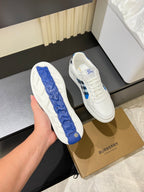 White Burberry sneakers with blue tread sole detail and black check side panel