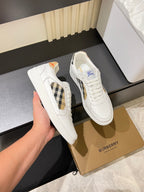 White Burberry check lace-up sneakers, side view held in hand