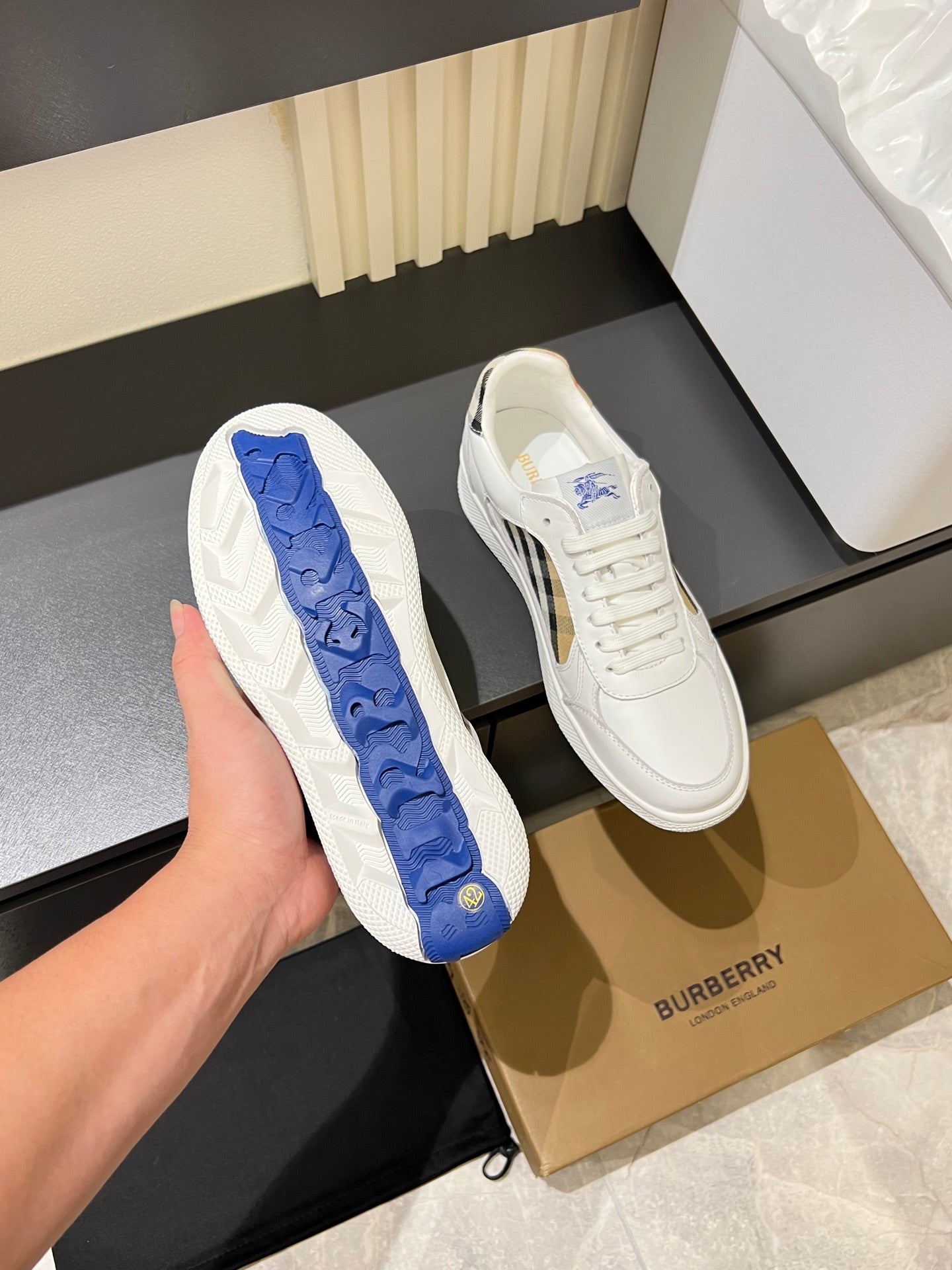 White Burberry check sneakers with blue tread outsole close-up